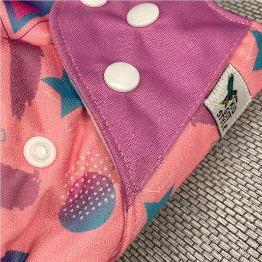 Close up of an 80s neon-style reusable cloth nappy