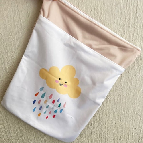 Hanging wet bag with smiling cloud and colourful rain
