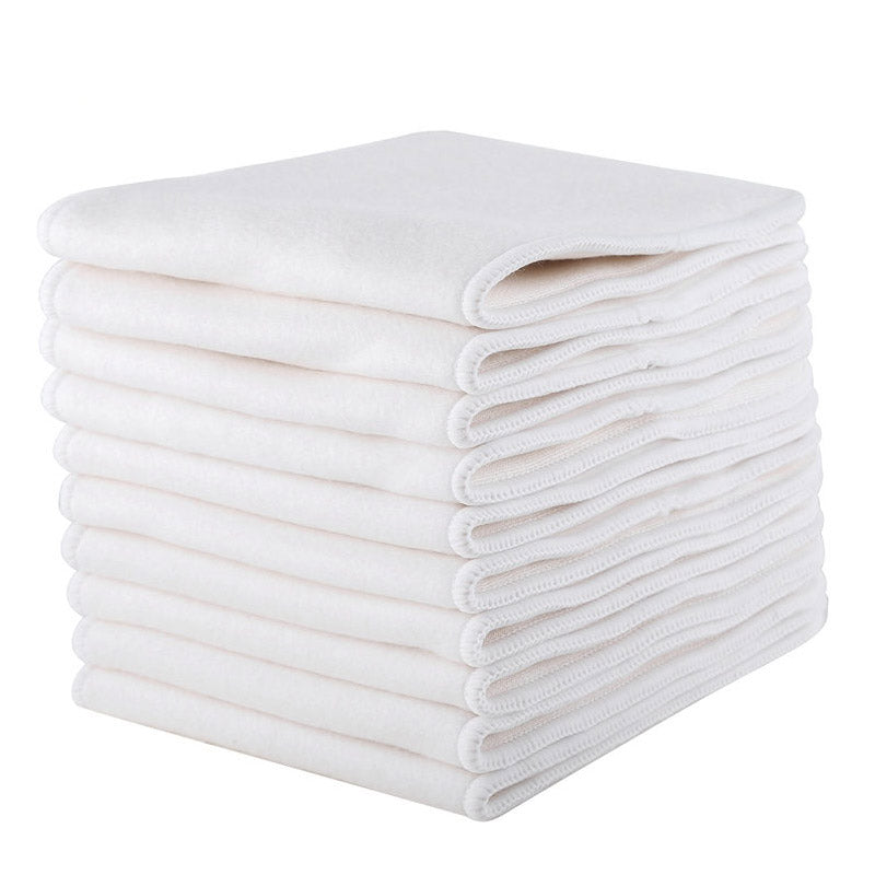 Several white bamboo cloth diaper inserts stacked