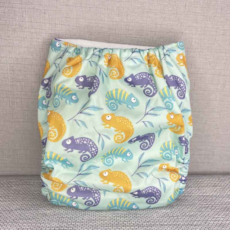 Back view of a reusable cloth diaper with an orange and blue chameleon pattern
