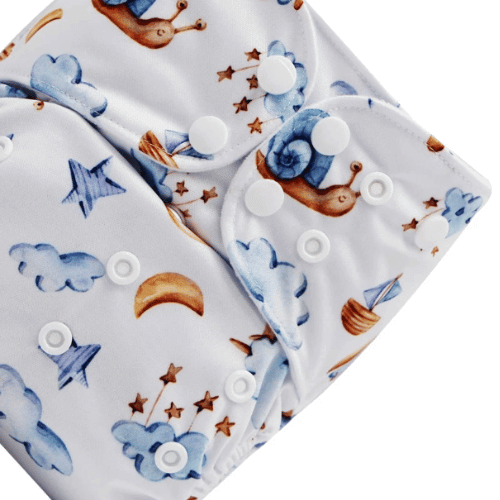 Close up of the In Your Dreams nappy, which has a pattern of blue and gold snails, clouds, stars, rainbows and more