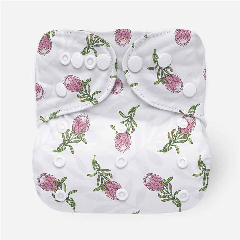 White reusable cloth nappy with a delicate pink protea pattern