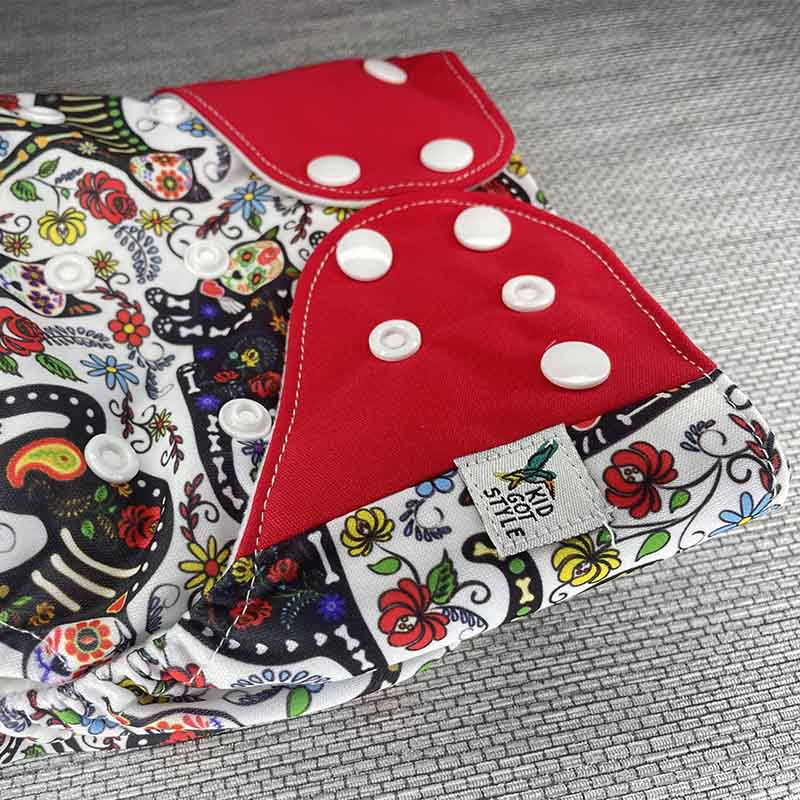 Close up of a sugar skull cloth diaper with red wings