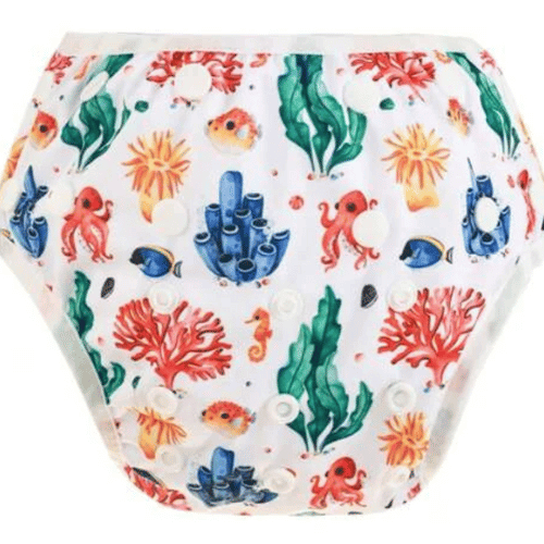 Reefs, seahorses and octopi in blue, green, red and orange colours pattern on a reusable swim nappy