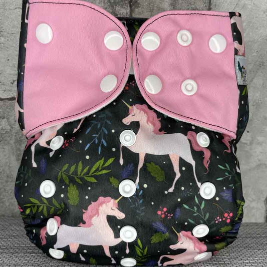 Front view of a reusable cloth diaper with unicorns and pink wings